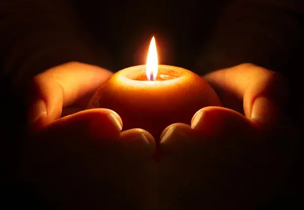 Depositphotos 57491911 stock photo prayer candle in hands
